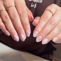 Nude nails with black polka dots